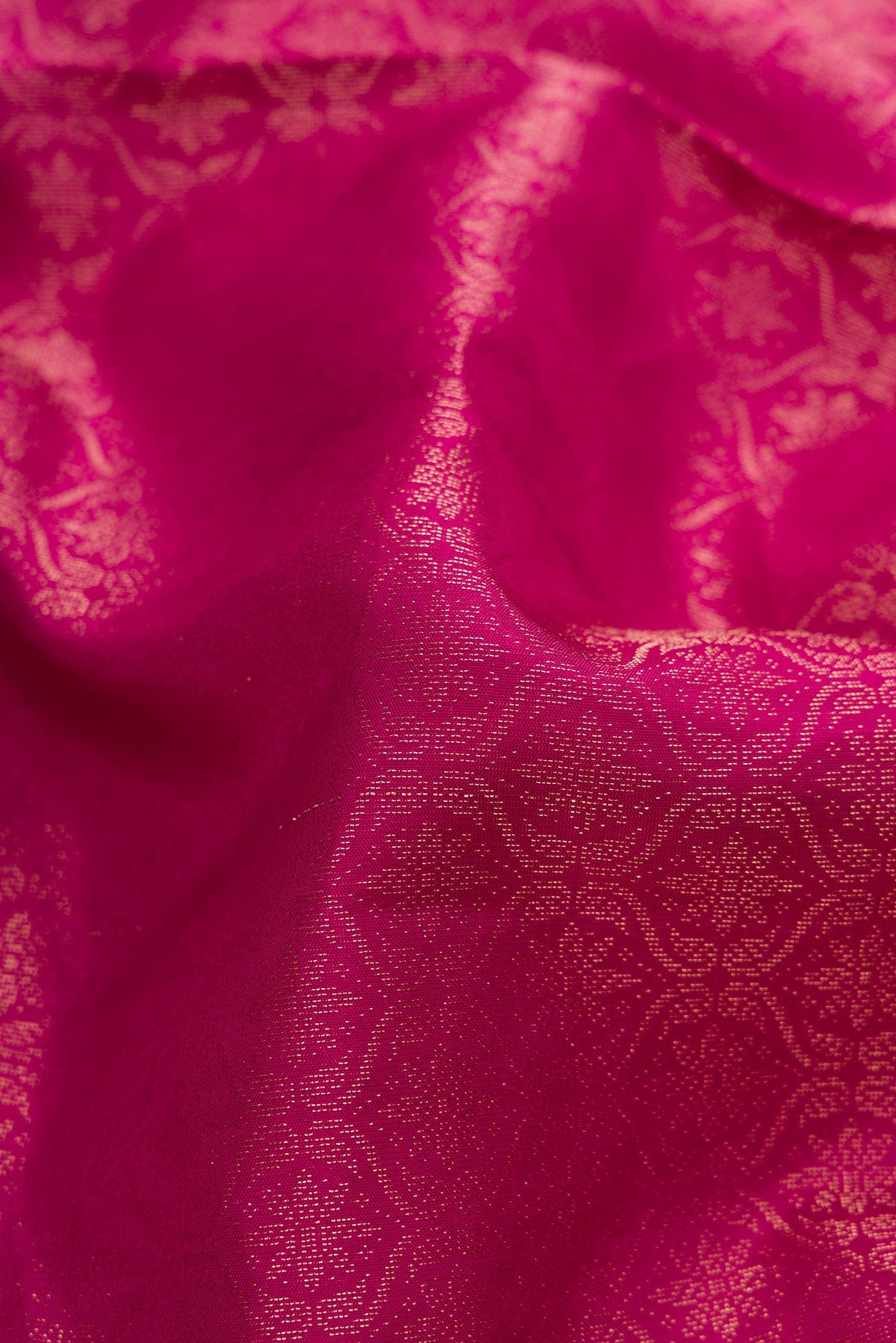 Close up of Magenta Soft Silk Saree with Zari Brocade on the body and Fancy Border.  displaying folds