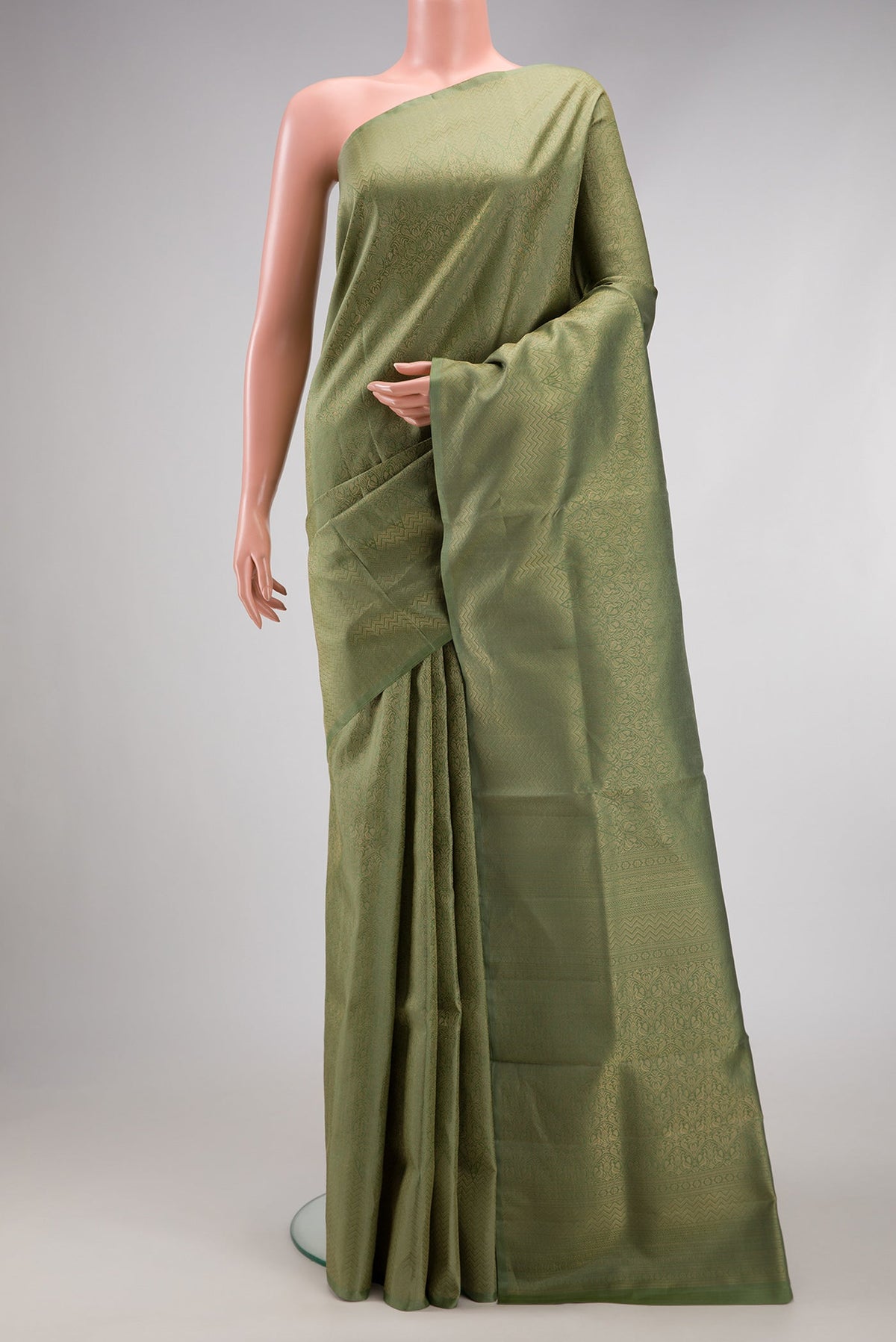 Sage Green Soft Silk Saree with Zari Brocade on the body and Fancy Border.  displayed on a mannequin