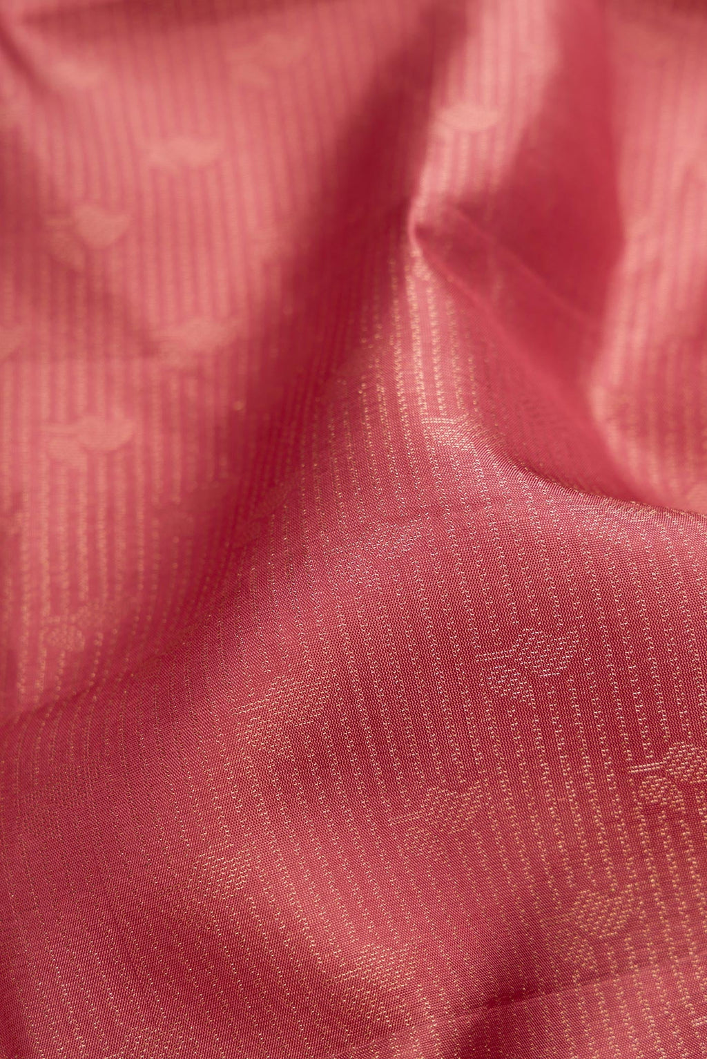 Close up of Rose Gold Soft Silk Saree with Zari Brocade on the body and Fancy Border.  displaying folds