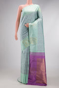 Light Blue Kanjivaram Silk Saree with Jacquard design on the body and Fancy Border.  displayed on a mannequin
