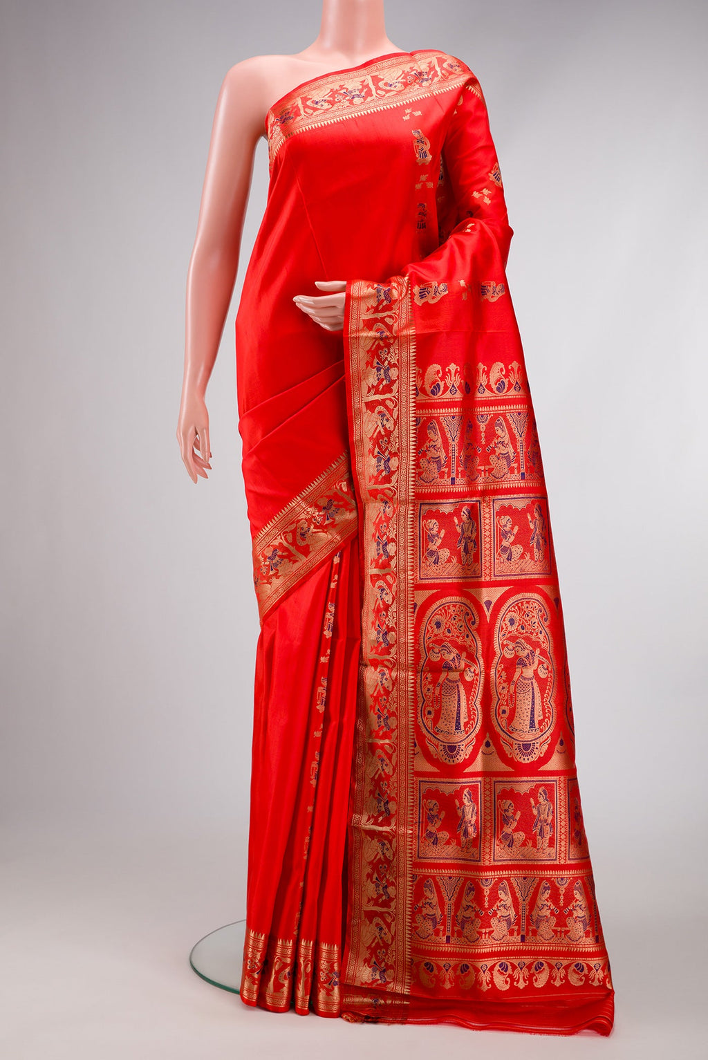 Orange Baluchari Silk Saree with Zari And Thread Butta on the body and Fancy Border.  displayed on a mannequin