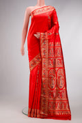 Orange Baluchari Silk Saree with Zari And Thread Butta on the body and Fancy Border.  displayed on a mannequin