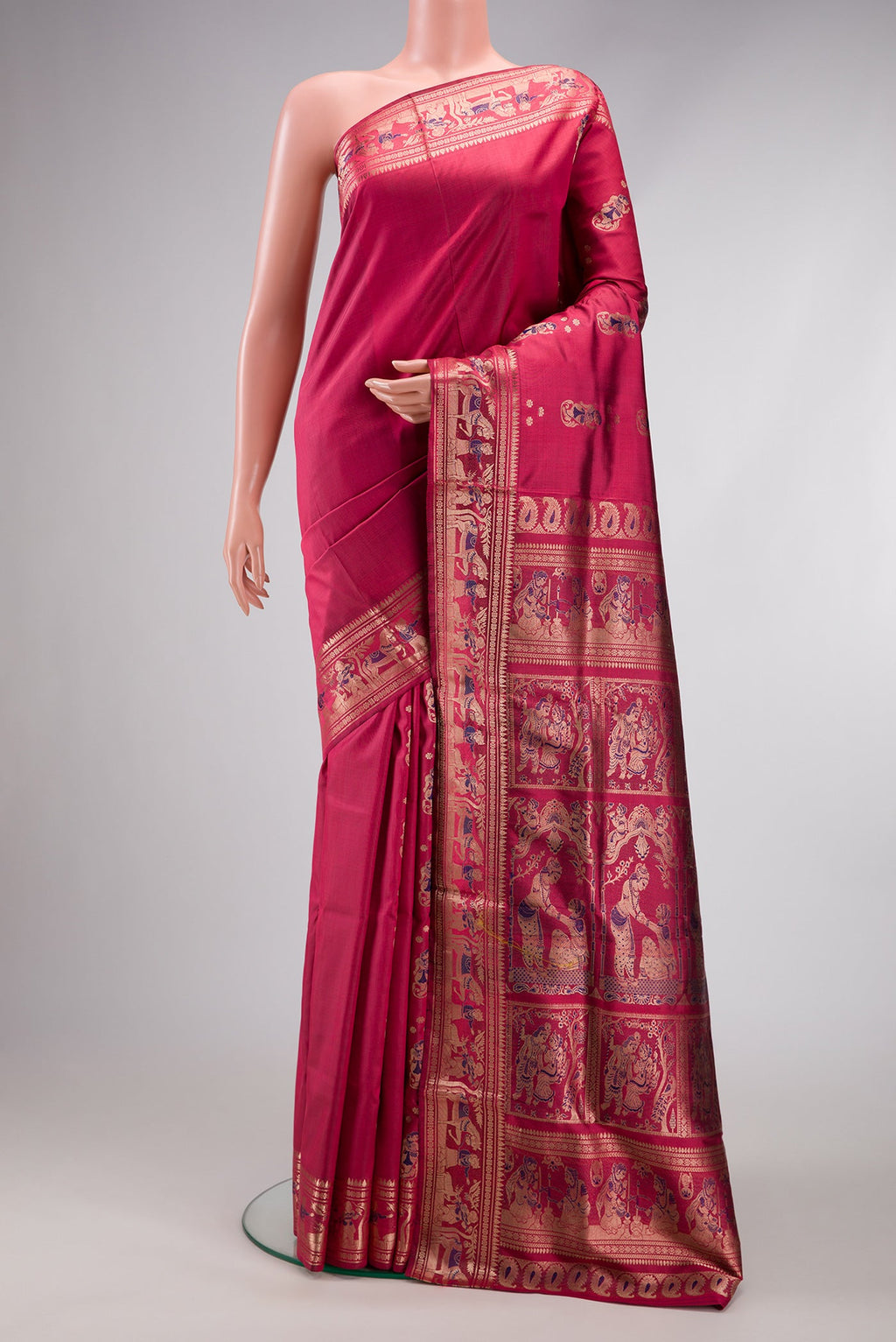 Maroon Baluchari Silk Saree with Zari And Thread Butta on the body and Zari Border.  displayed on a mannequin