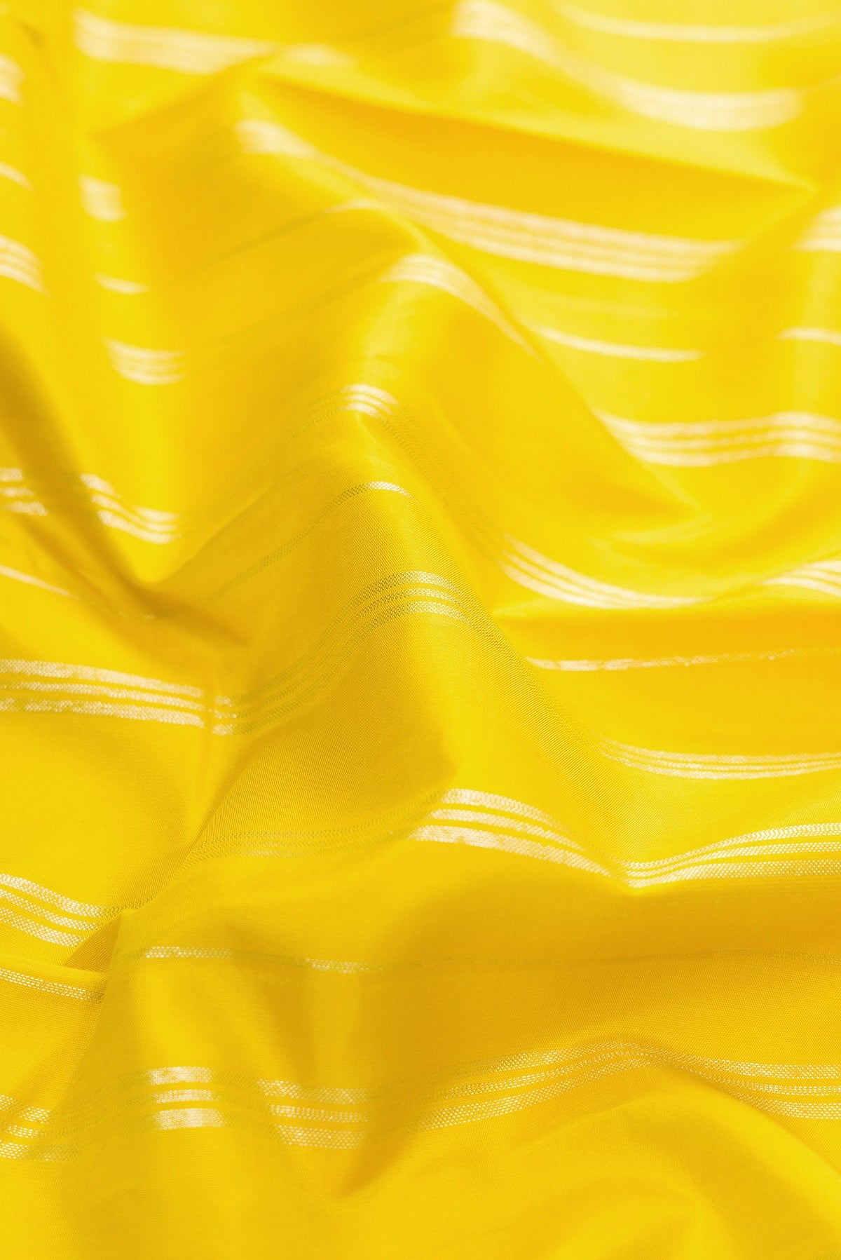 Close up of Lemon Yellow Kanjivaram Silk Saree with Stripes on the body and Without Border.  displaying folds