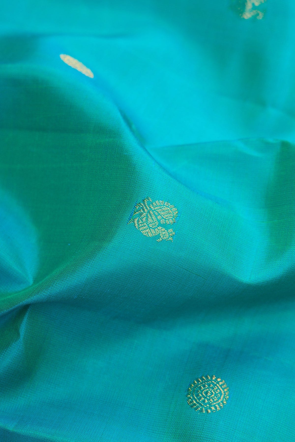 Close up of Blue Kanjivaram Silk Saree with Zari Butta on the body and Zari Border.  displaying folds