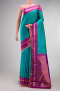 Blue Kanjivaram Silk Saree with Zari Butta on the body and Zari Border.  displayed on a mannequin