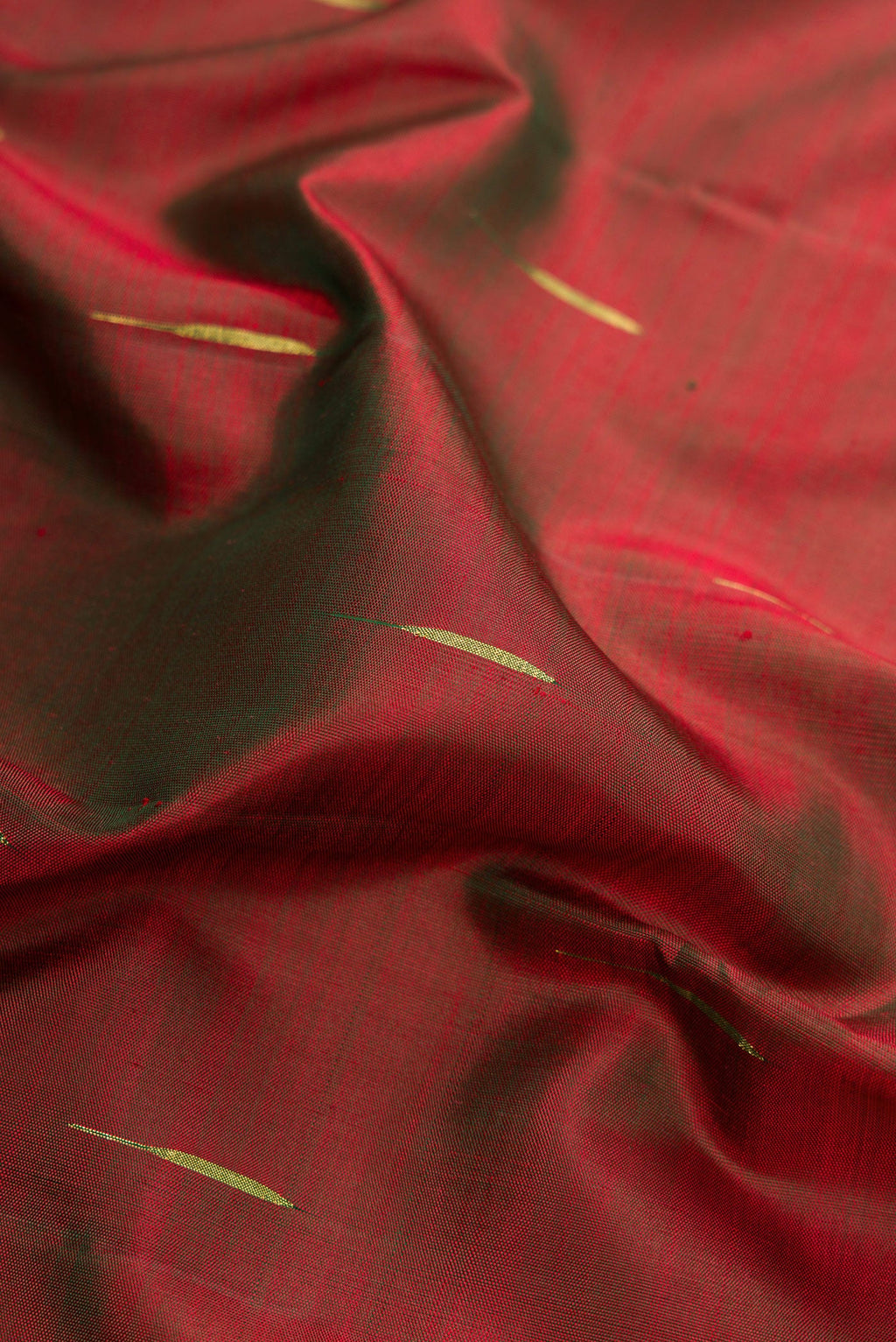 Close up of Mehandi Green Dual Tone Kanjivaram Silk Saree with Zari Butta on the body and Zari Border.  displaying folds