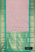 Lilac Kanchipuram Silk Saree with Zari Butta on the body and Zari Border.  displayed on a mannequin