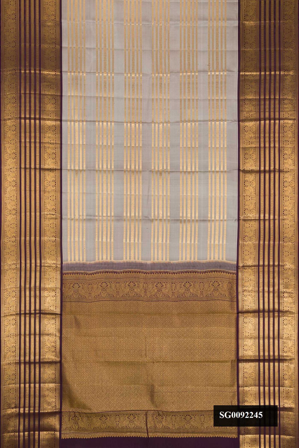 Grey Dual Tone Kanchipuram Silk Saree with Stripes on the body and Zari Border.  displayed on a mannequin