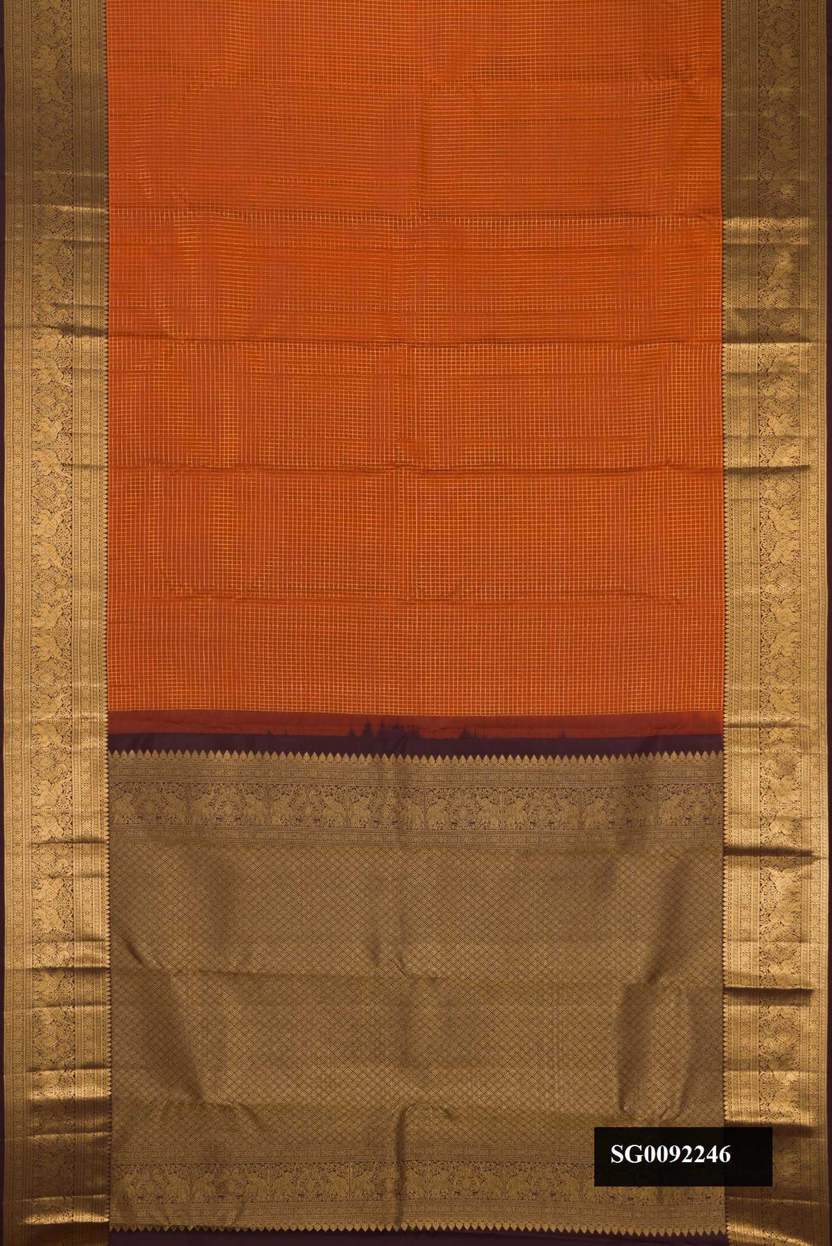 Brick Orange Dual Tone Kanchipuram Silk Saree with Checked design on the body and Zari Border.  displayed on a mannequin