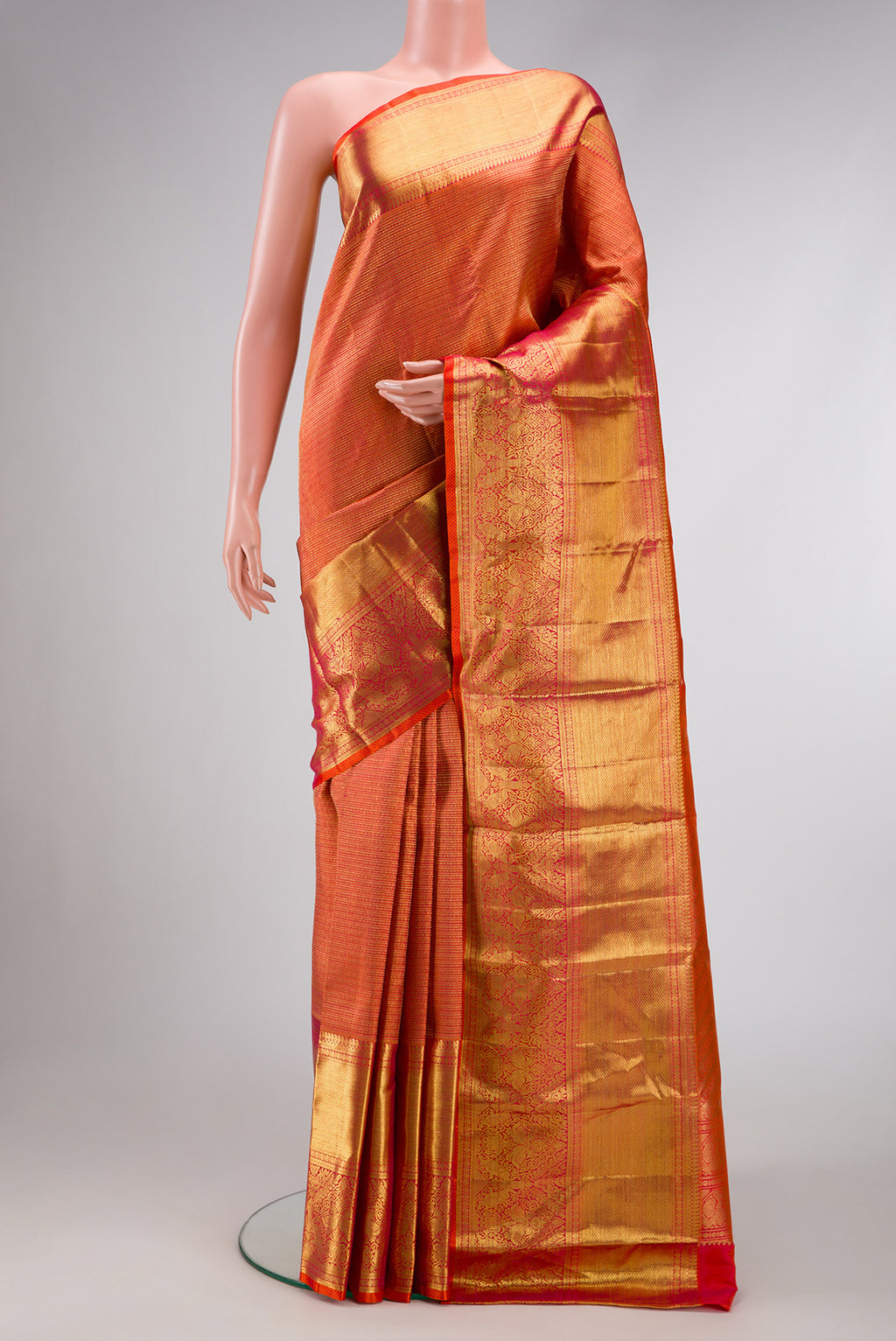Magenta Kanjivaram Silk Saree with Zari Butta on the body and Zari Border.  displayed on a mannequin