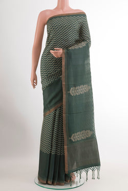 Mustard Tussar Silk Saree with Printed design on the body and Zari Border.  displayed on a mannequin