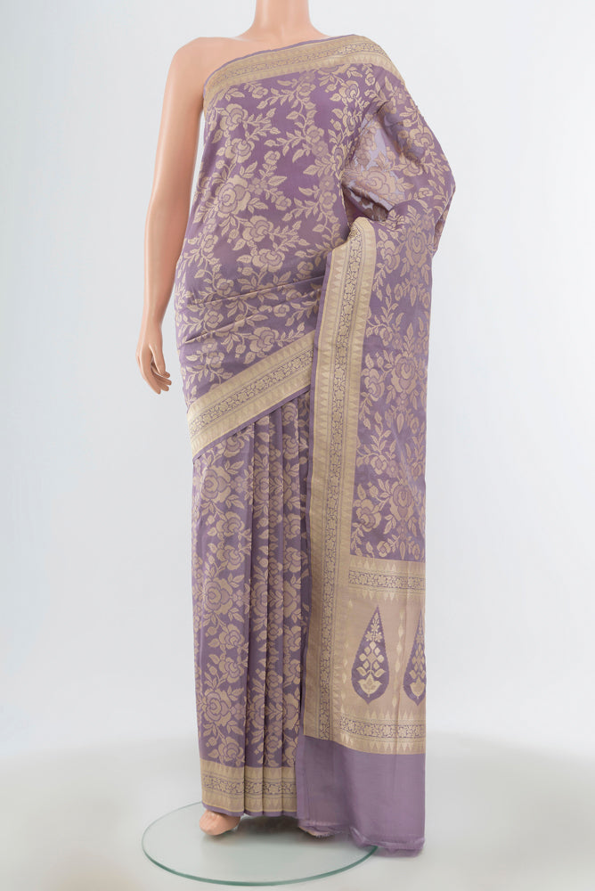 Rose Gold Kanjivaram Tissue Silk Saree with Zari Brocade on the body and Zari Border.  displayed on a mannequin