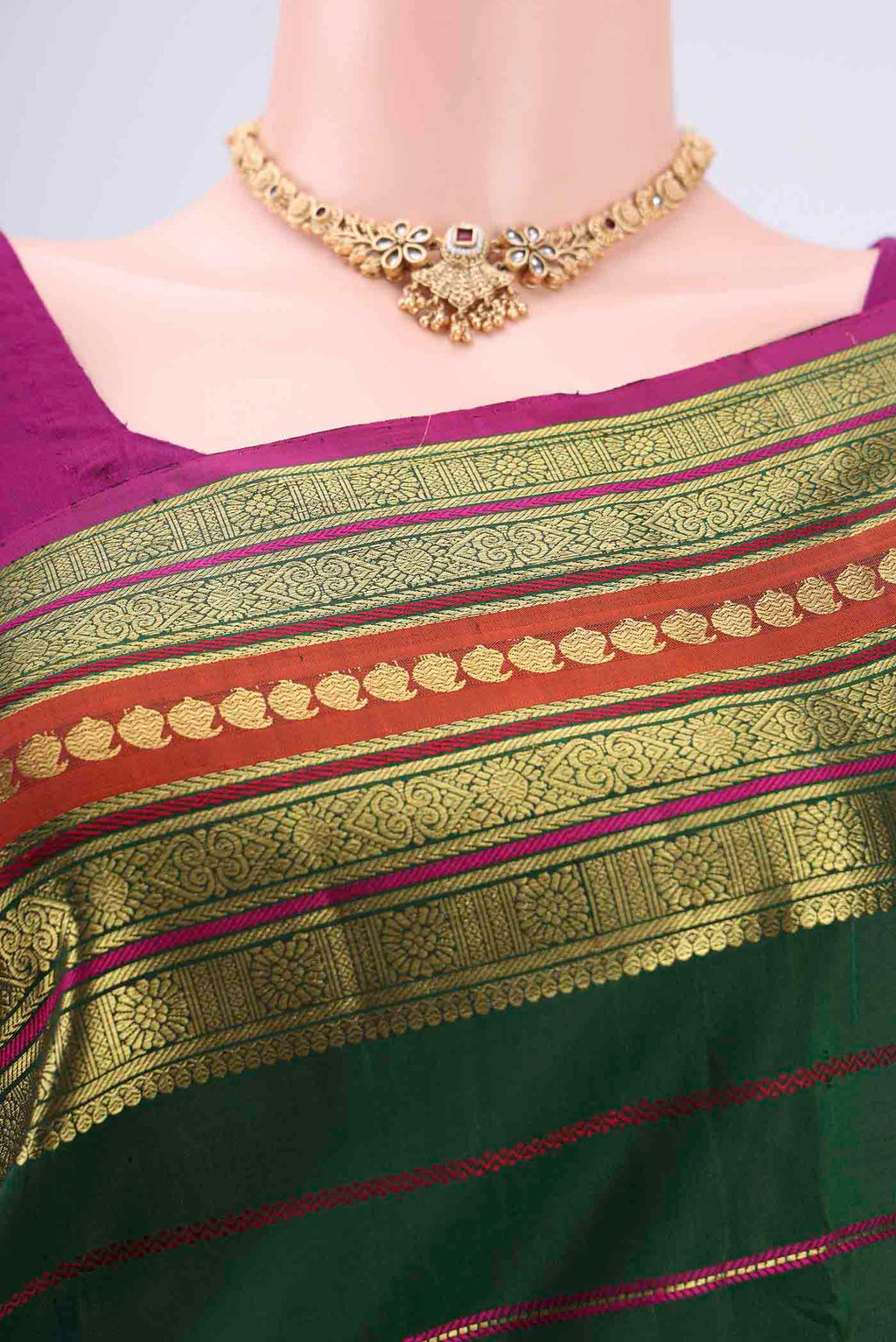 Close up image of the blouse of Beige Chanderi Silk Cotton Saree with Ajrakh Print on the body and Zari Border. 