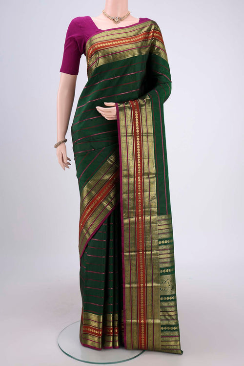 Beige Blended Kota Cotton Saree with Embroidery on the body and Thread Border.  displayed on a mannequin