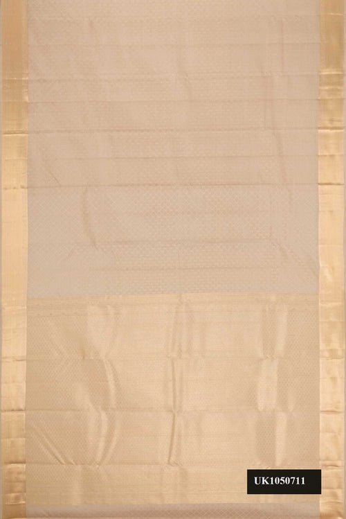 Beige Dual Tone Kanchipuram Silk Saree with Jacquard With Zari Butta on the body and Zari Border.  displayed on a mannequin