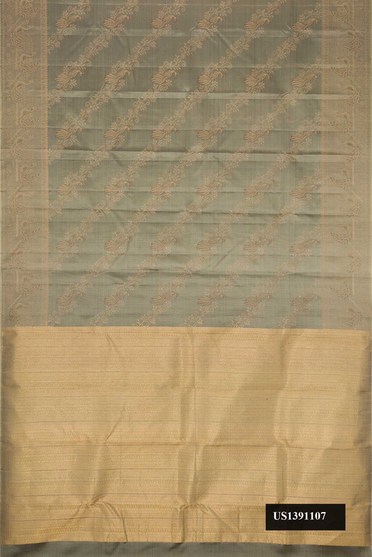 Grey Dual Tone Kanchipuram Silk Saree with Zari And Thread Butta on the body and Zari Border.  displayed on a mannequin