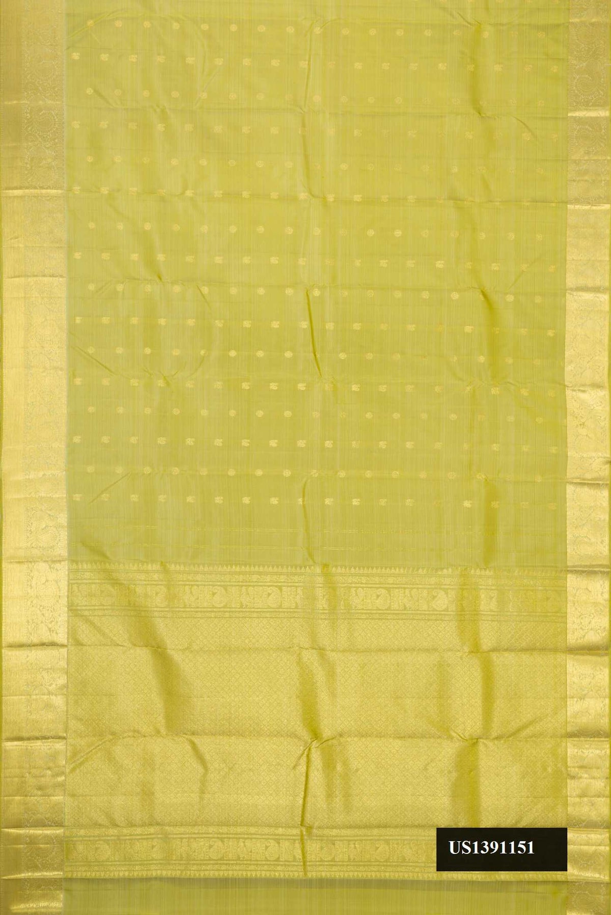 Green Dual Tone Kanchipuram Silk Saree with Zari Butta on the body and Zari Border.  displayed on a mannequin