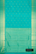 Green Dual Tone Kanchipuram Silk Saree with Zari Butta on the body and Zari Border.  displayed on a mannequin