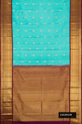 Sky Blue Dual Tone Kanchipuram Silk Saree with Zari Butta on the body and Zari Border.  displayed on a mannequin