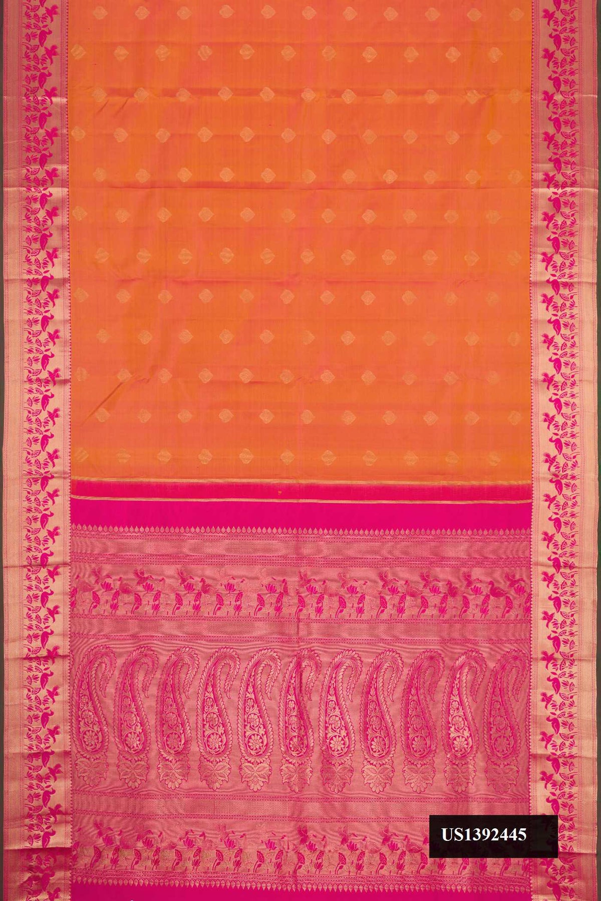 Brick Orange Dual Tone Kanchipuram Silk Saree with Zari Butta on the body and Zari Border.  displayed on a mannequin