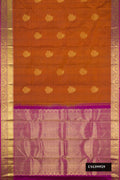 Brick Orange Dual Tone Kanchipuram Silk Saree with Zari Butta on the body and Zari Border.  displayed on a mannequin