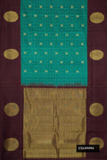 Green Dual Tone Kanchipuram Silk Saree with Checked design on the body and Fancy Border.  displayed on a mannequin